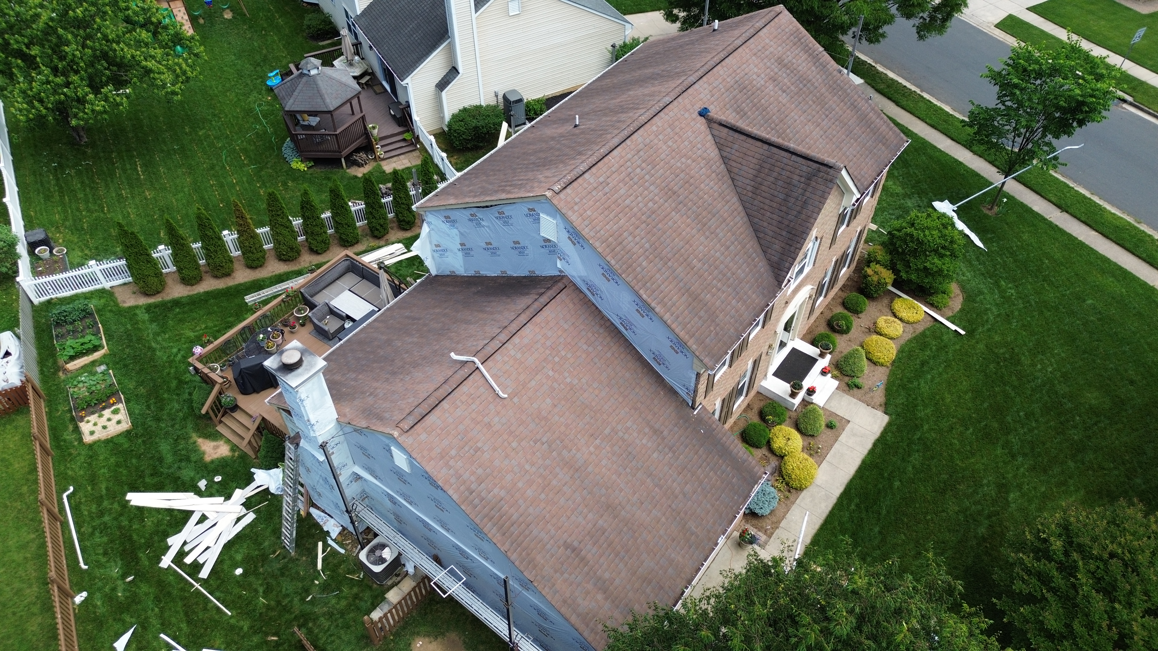 Old faded vinyl siding on a Gambrills MD home before replacement by Prime Roofing & Siding