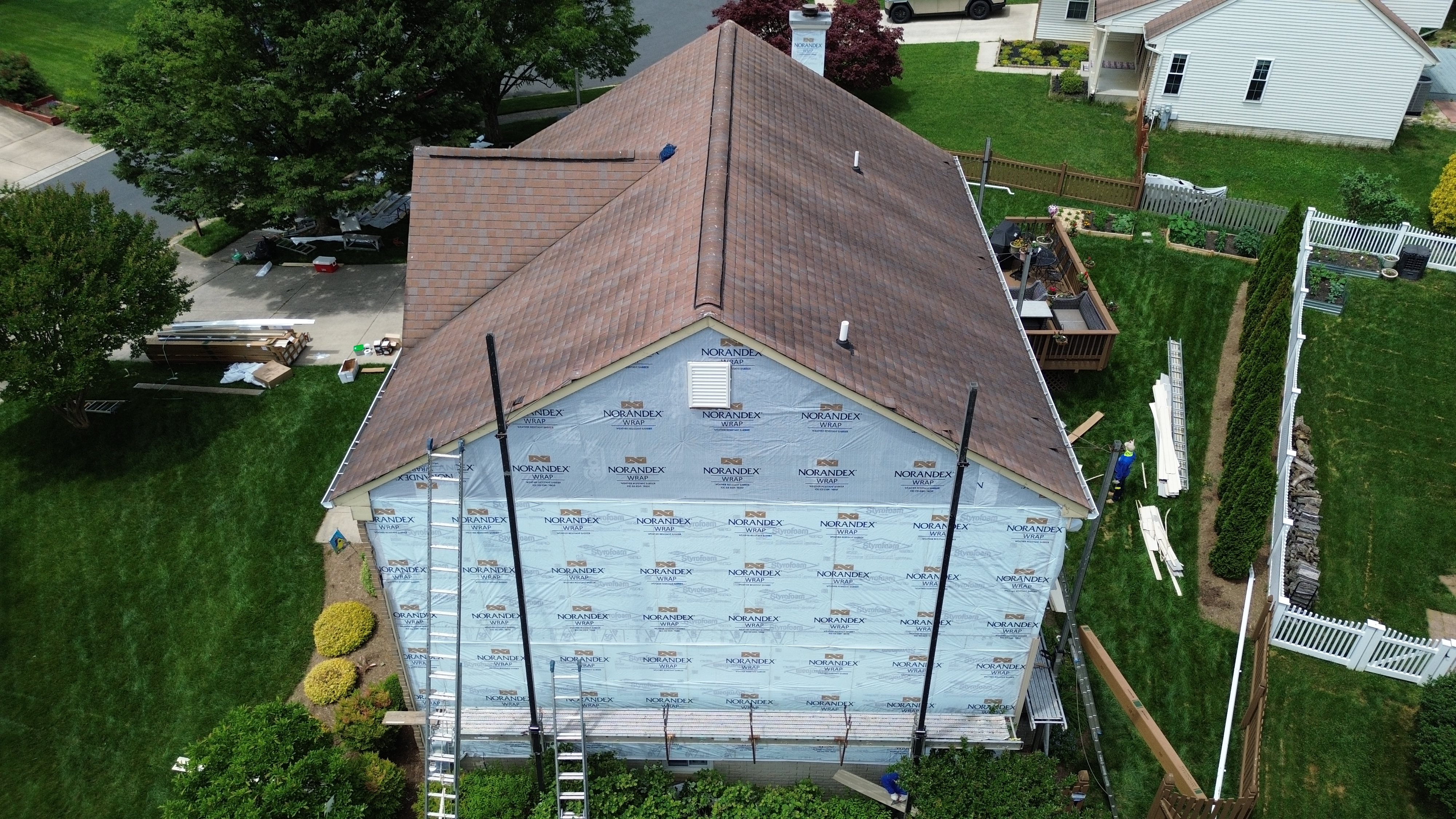 Front elevation of a Gambrills MD home showing aged siding before replacement