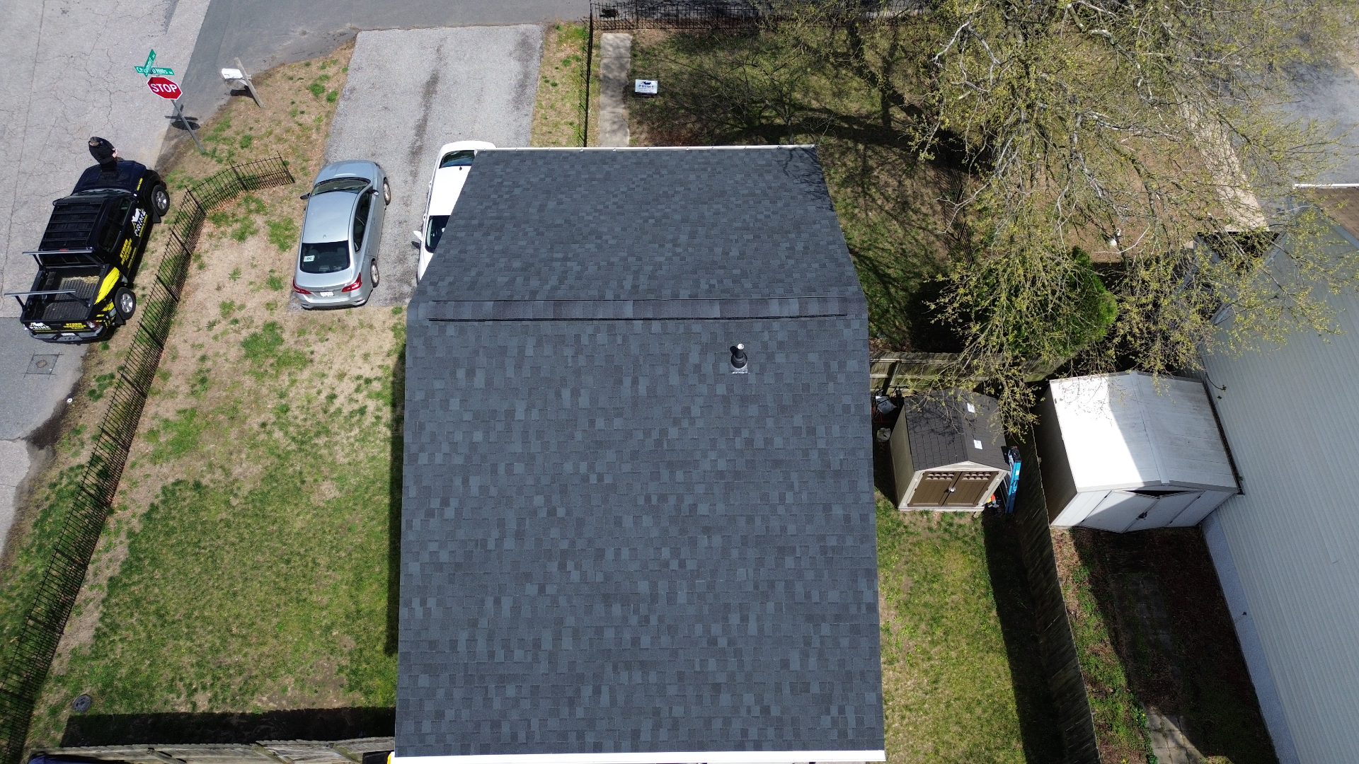 Aerial view of completed charcoal black architectural shingle roof on a Crofton MD home by Prime Roofing & Siding