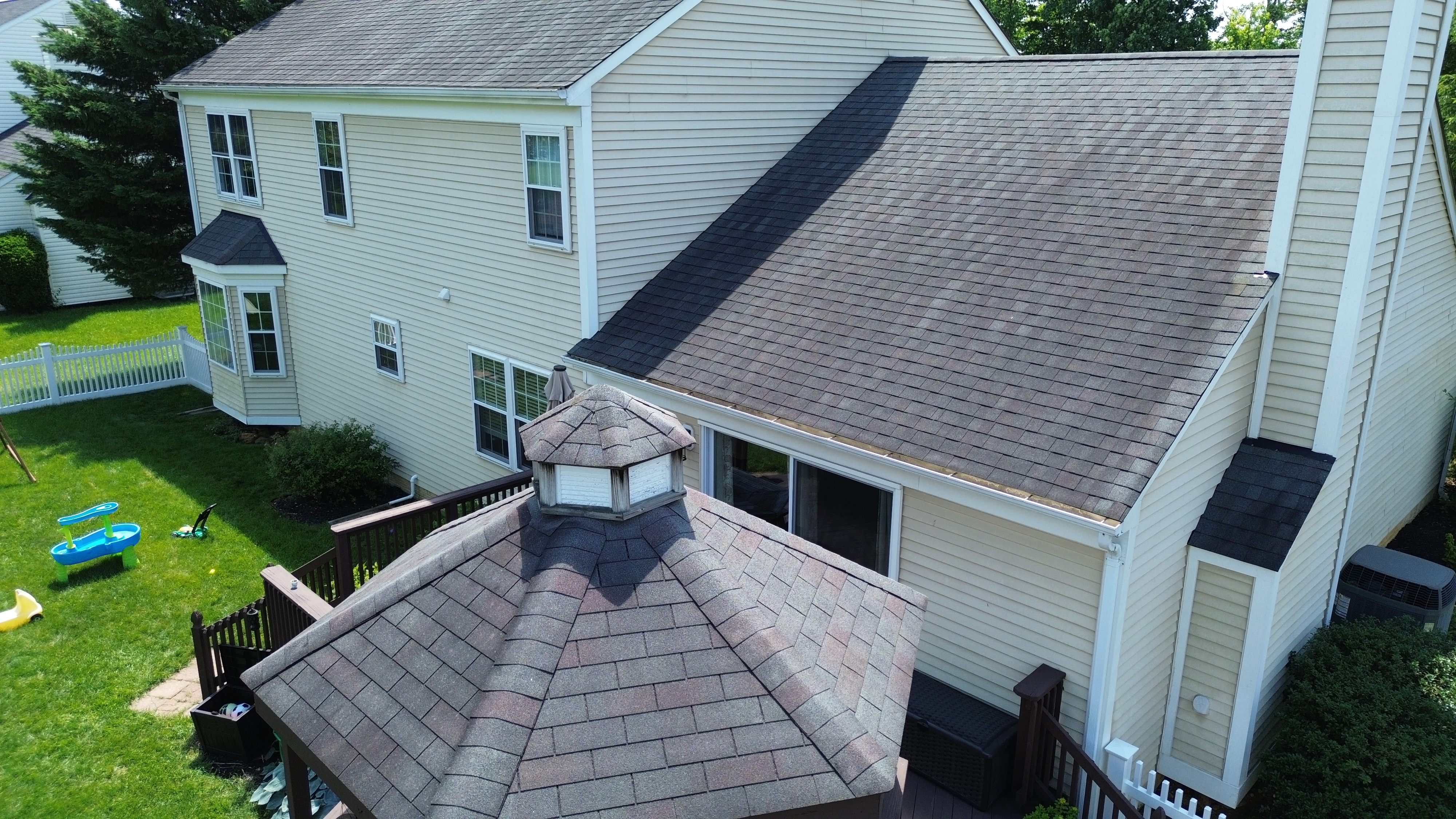 Close-up of warped siding panels on a Crofton Maryland home before Prime Roofing & Siding replacement