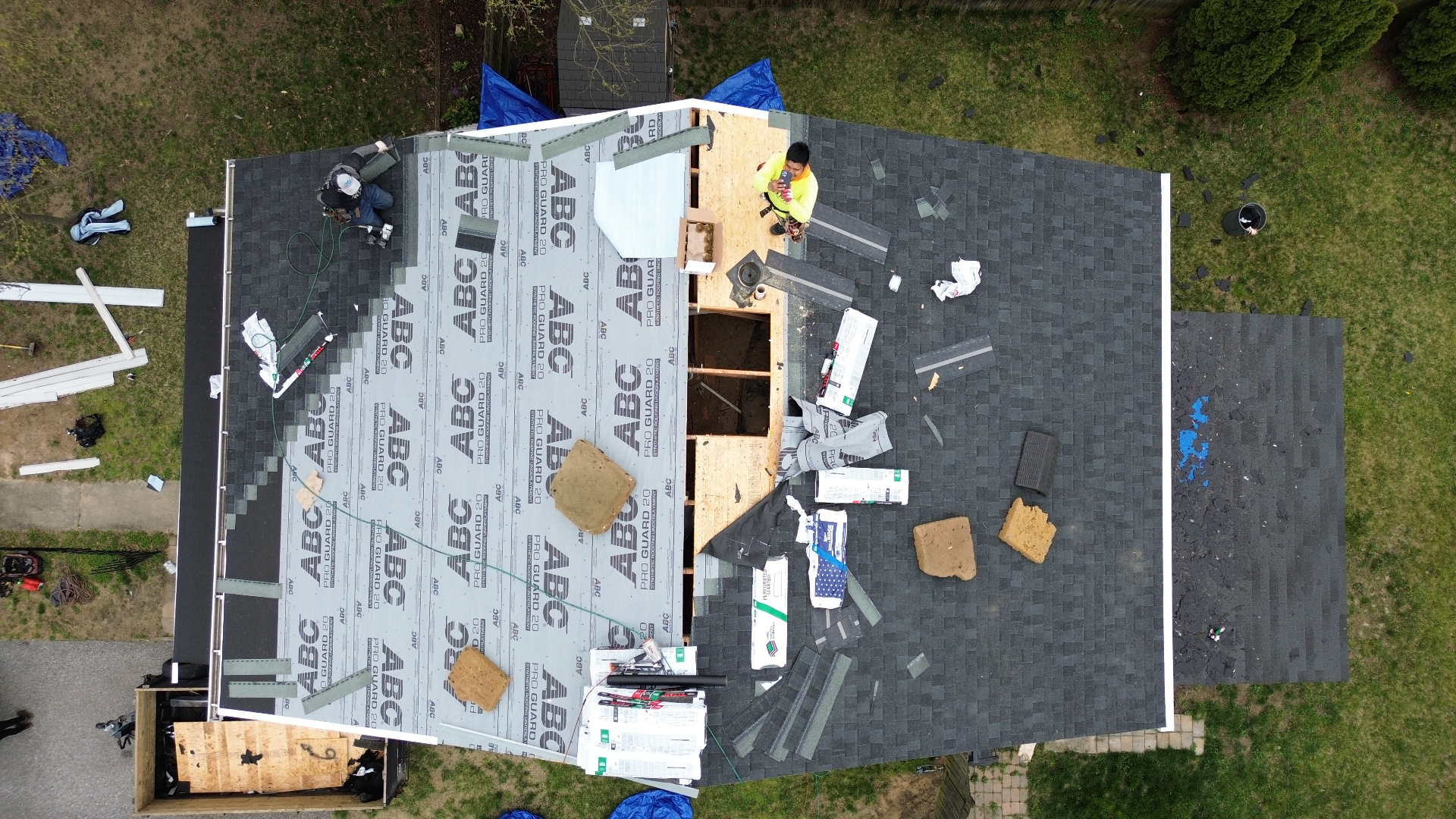 Aerial view of a Crofton MD roof mid-replacement with shingles being installed by Prime Roofing & Siding crew