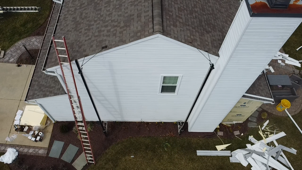 Aerial view of a Gambrills Maryland home mid-siding tear-off by Prime Roofing & Siding