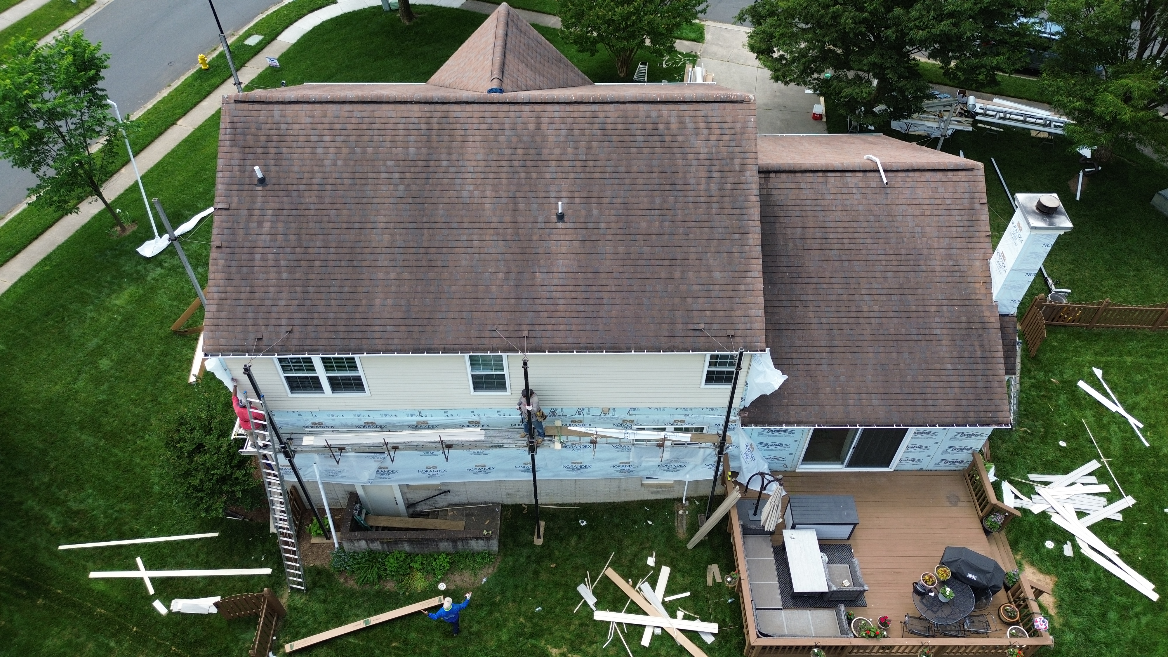 Damaged siding panels on a Gambrills Maryland home before Prime Roofing & Siding replacement