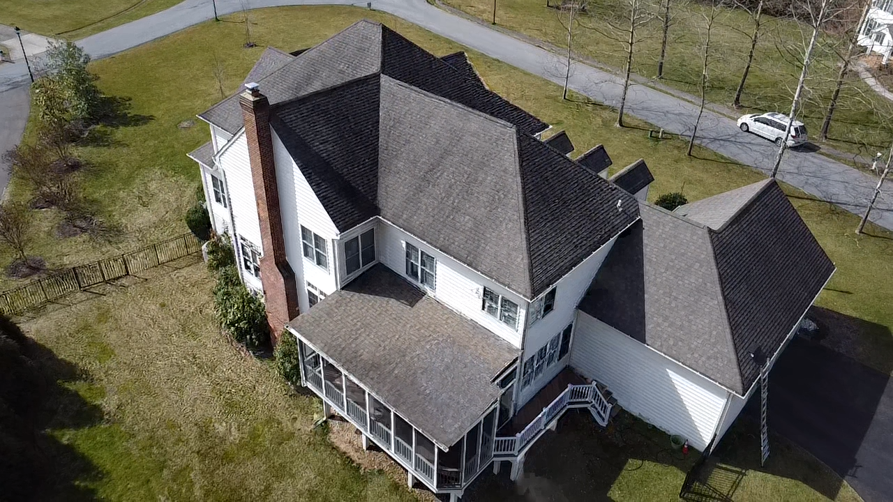 Damaged roof shingles on a Millersville Maryland home before Prime Roofing & Siding replacement