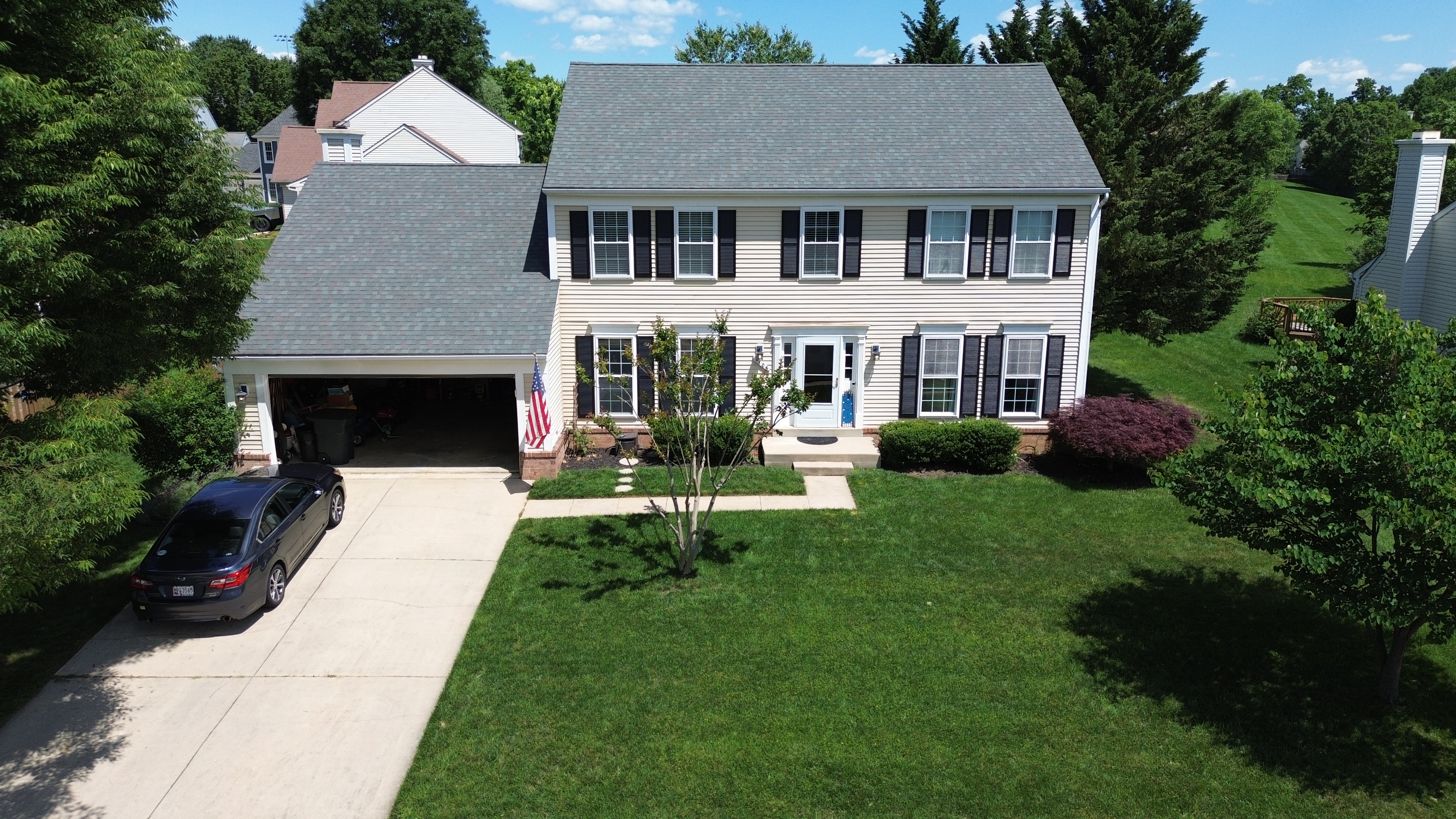 Faded and damaged vinyl siding on a Crofton MD home before replacement by Prime Roofing & Siding